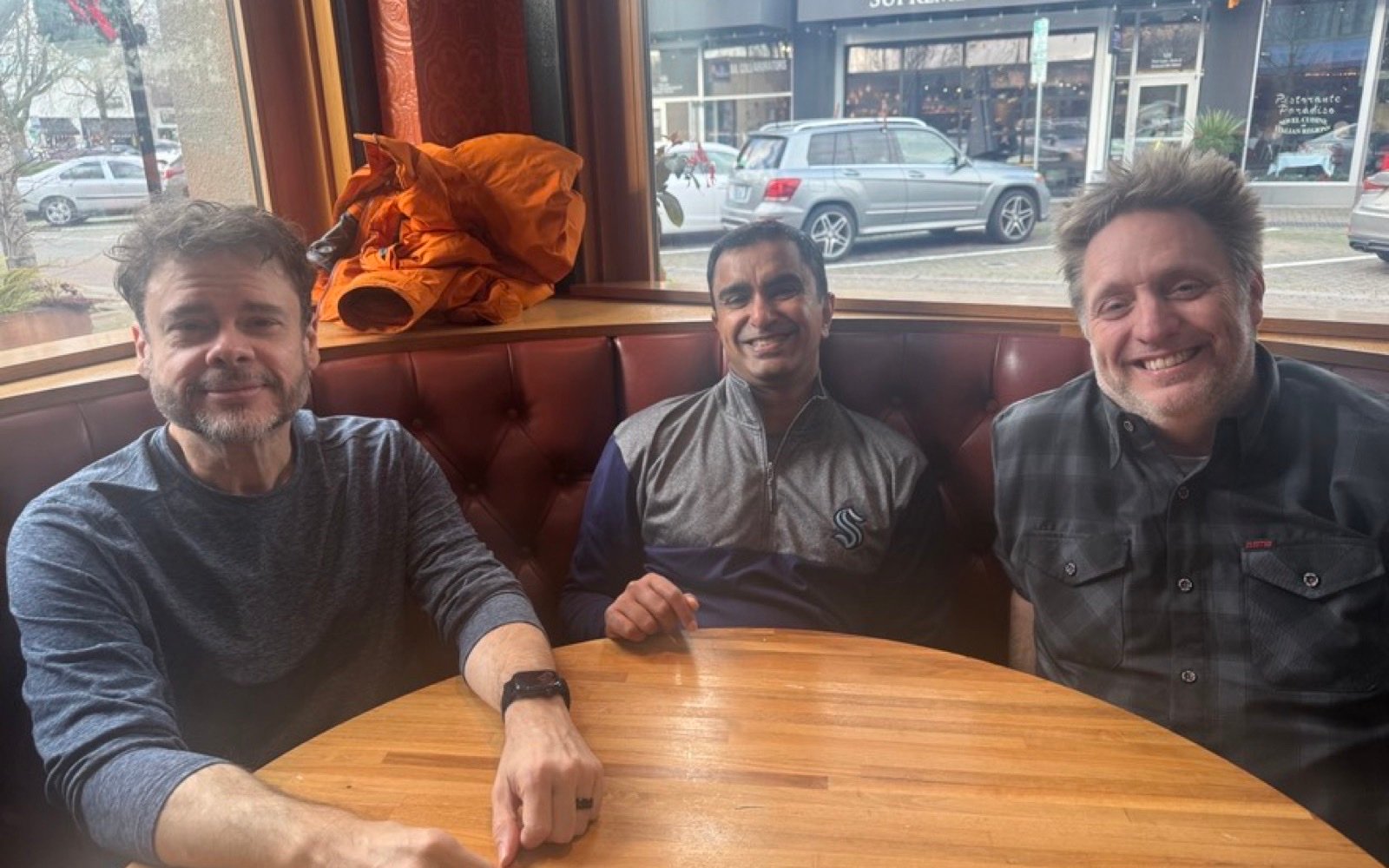 Three people smiling in a booth by the window at Cactus in Kirkland, December 17, 2025